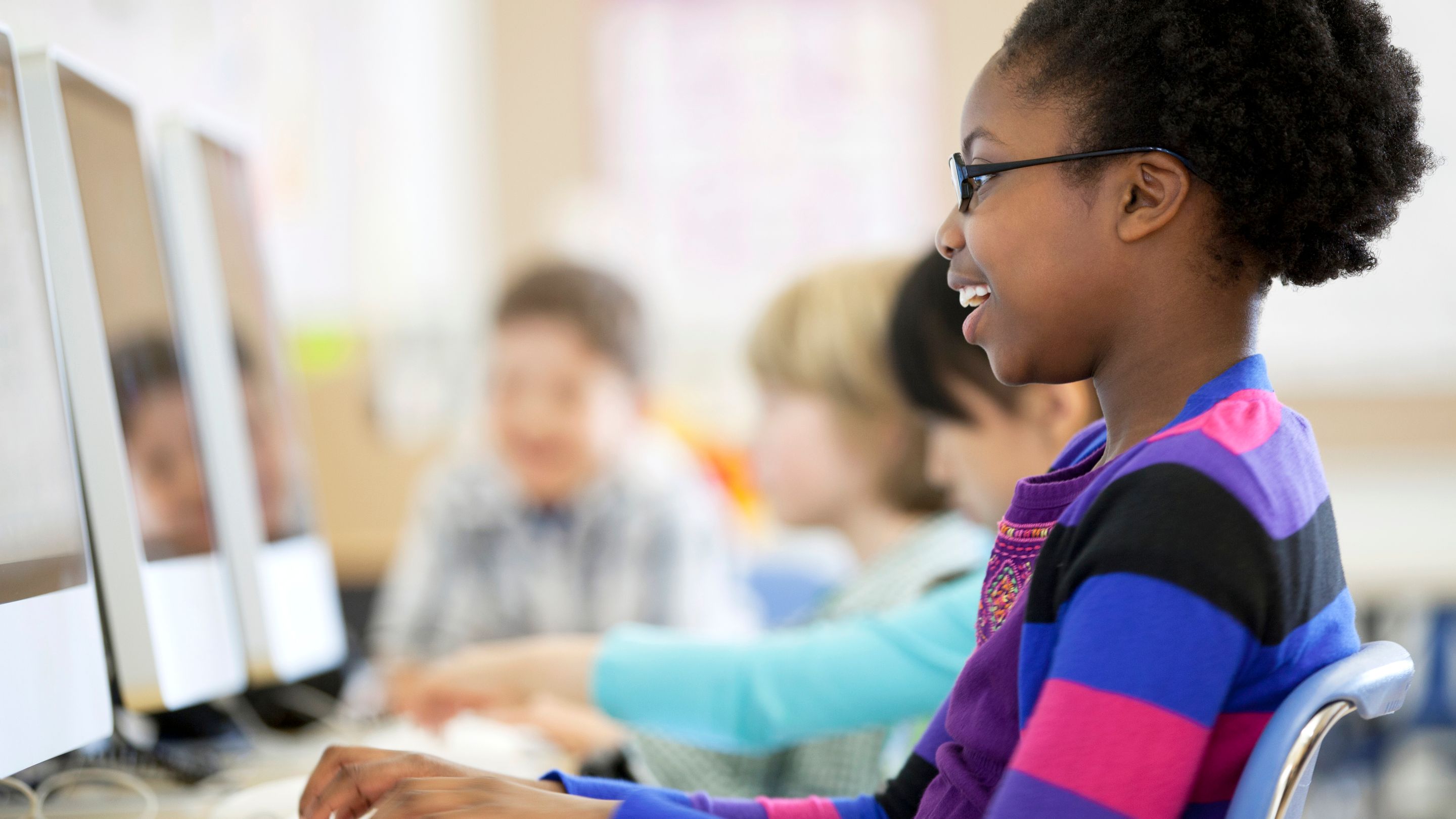 stock-photo-elementary-students-learning-in-computer-lab-156949719